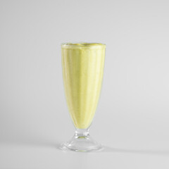 A refreshing green smoothie in a tall glass cup against a clean, white background, perfect for healthy living concepts.