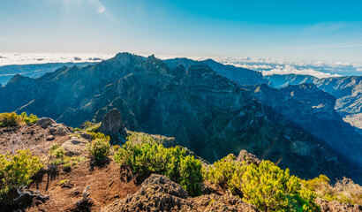 Hiking on the highest peak of Madeira Pico Ruivo next to the cottage Abrigo do Pico Ruivo. Views of the surrounding mountains lanscape during sunny day