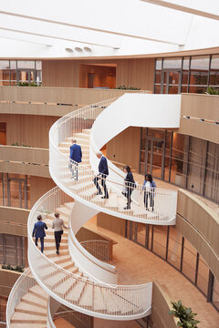High angle view of business people moving up of steps in office