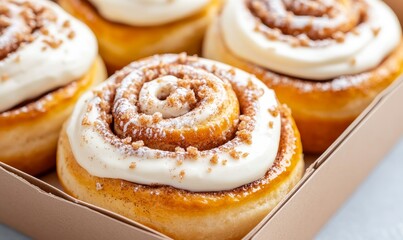 Fototapeta premium Freshly Baked Cinnamon Rolls With Cream Frosting in a Cardboard Box at a Bakery