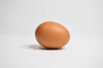 One chicken egg isolated on white background. Landscape photo.