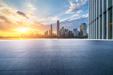 Empty square floor with modern city buildings scenery at sunset in Guangzhou. car advertising background.