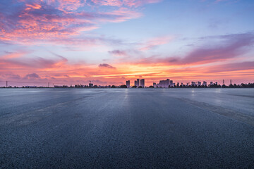 Asphalt road square and skyline with beautiful sky clouds at sunrise. car background.