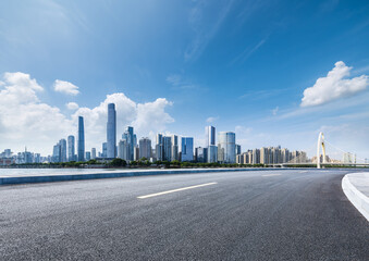 Fototapeta premium Asphalt highway road and city skyline with modern buildings scenery in Guangzhou. car background.