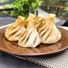 Fried khinkali in a plate on the table