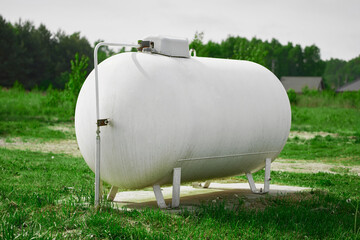 White propane tank in field powers rural house