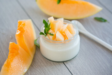 sweet homemade yogurt in a jar with pieces of ripe melon