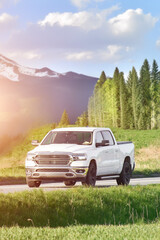 White pickup truck driving on rural road © AlexGo