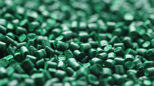 Close-up of green colour masterbatch. Pigments for plastic injection moulding. Rotating view 