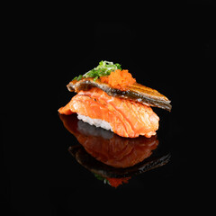 Close-up of gourmet sushi with salmon, eel, roe, and garnish on black background, showcasing fine dining and culinary art.