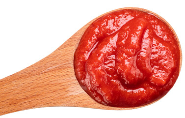 Wooden spoon of tomato sauce or ketchup close-up on a white background. Top view.