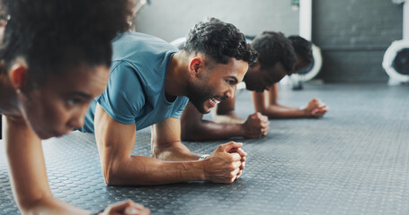 Exercise, plank and power with group friends on gym floor together for training or workout. Fitness, strength and sports with athlete people in health club for intense challenge or performance