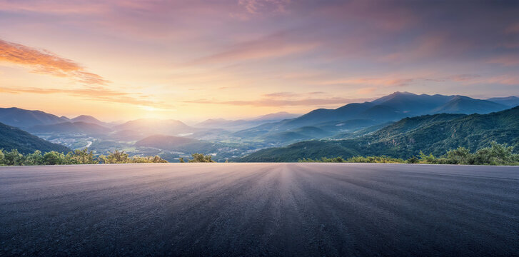 Empty asphalt road leading to distant mountain ranges and valley at sunset. High quality photo