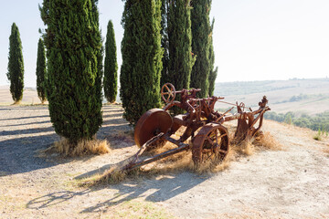 San Quirico D'Orcia, Siena Italy - old plow on the hills of Valle D'Orcia
