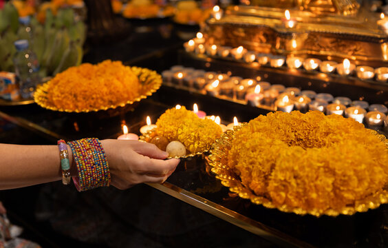 Indian woman holding offering for God Ganesha.