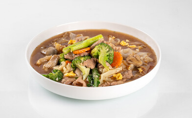 Delicious mixed vegetable and meat stir-fry in a white bowl, featuring fresh broccoli, carrots, and hearty chunks of meat.