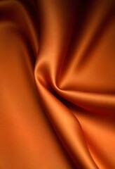 Abstract background luxury cloth or liquid wave smooth, flowing orange silk fabric with soft folds and highlights.