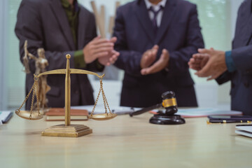 Three lawyers in a meeting at the table in an office, discussing business, civil and commercial law, labor law, marketing and advertising law,offering legal consulting and case management services.