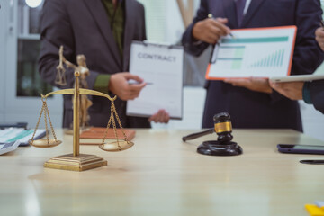 Three lawyers in a meeting at the table in an office, discussing business, civil and commercial law, labor law, marketing and advertising law,offering legal consulting and case management services.