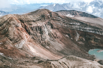View of mountains and volcanoes from the edge of the crater