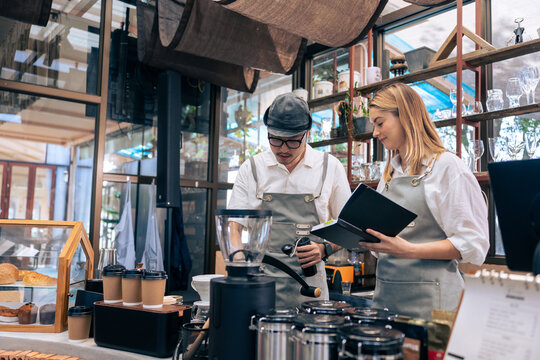 Asian attractive male barista or waiter working in coffeehouse shop