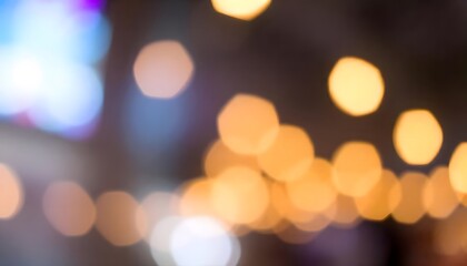 Obraz premium City street at night, with blurred lights reflecting on a wet pavement. Blurred background with soft warm-toned bokeh-light 