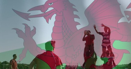 Animation of flag of wales over diverse male rugby players playing rugby - Powered by Adobe