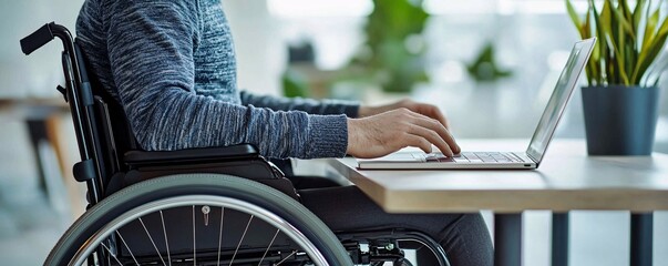 Man in Wheelchair Using Laptop
