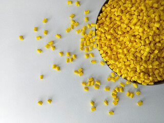 Yellow masterbatch granule, yellow polymer granules in a cup, cold cutting type granule texture,...