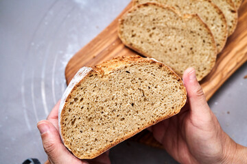 hand holding a homemade wholegrain bread