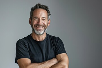 Fototapeta premium smiling man with crossed arms over gray background
