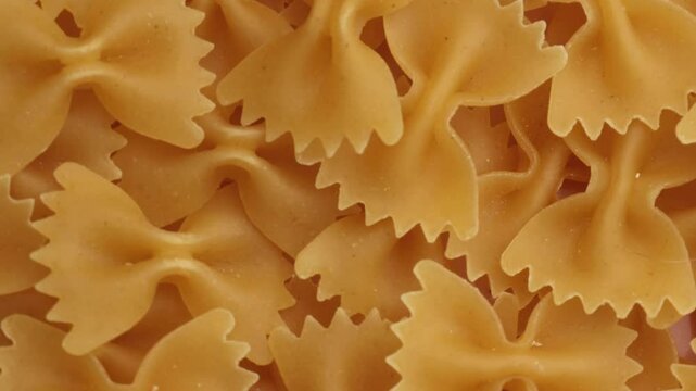 dry farfalle pasta, rotation in circle. Farfalle italian pasta, Turning 