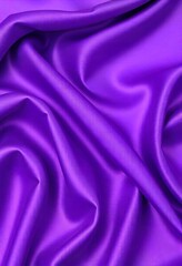 Fototapeta premium Smooth flowing purple satin fabric with soft wavy. flowing purple satin with soft folds and highlights.