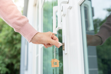 Landlord key for unlocking house is plugged into the door. Second hand house for rent and sale. Owner use hand unlock door mortgage for new home, buy, sell, renovate, investment, owner, estate