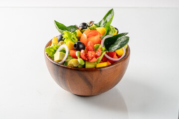 Fresh and vibrant vegetable salad served in a wooden bowl. Perfect for healthy eating and vegetarian diet.