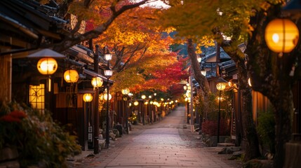 Fototapeta premium Illuminated Street Lined with Traditional Japanese Buildings and Autumn Trees