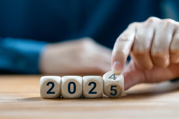 Hand Women flip wooden cube change from the number 2024 to 2025, Happy new year 2025, celebration,...