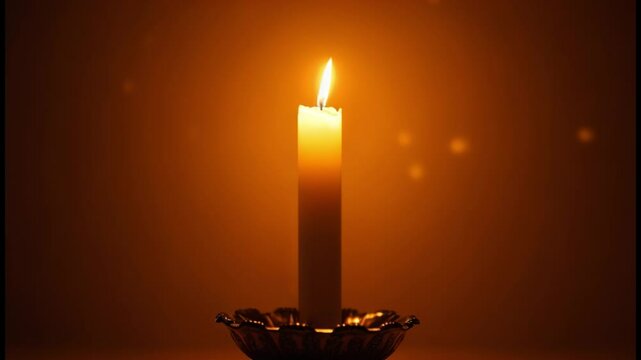 Glowing Paschal candle with rich designs, bokeh and warm golden light