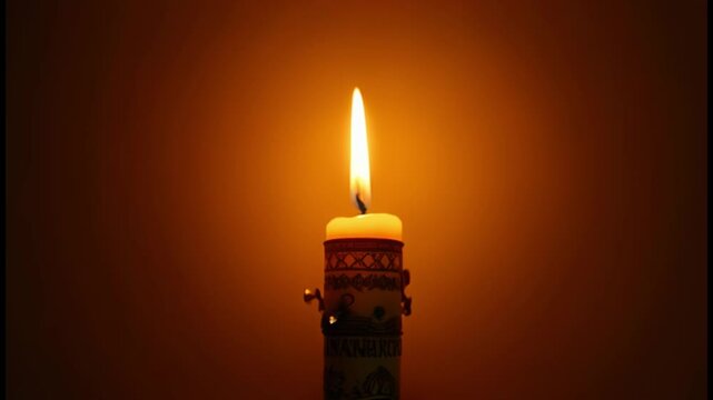 Glowing Paschal candle with rich designs, bokeh and warm golden light