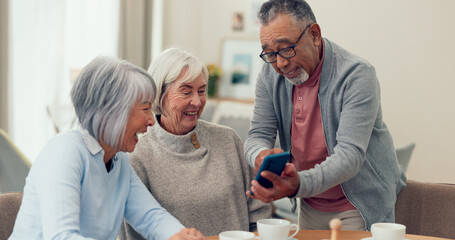Cellphone, tea and senior friends at table for funny meme, snacks and retirement together in house. Group, memory and man with elderly women for breakfast, communication and bonding with smile