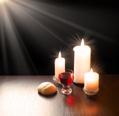 A bowl of wine and bread on the table. Communion symbols