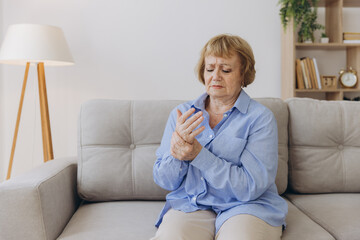 Elderly woman suffering from pain in hand, arthritis old person and senior woman female suffering...