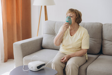 Sick senior woman has a viral infection or flu, labored breathing, asthma. An elderly female is...