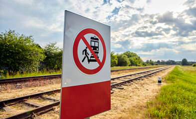 Warning Sign Prohibiting Access to Railway Tracks Under the Bright Sunlight