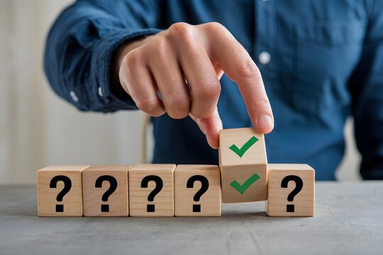 Hand selects wooden block with green checkmark from row of question marked blocks