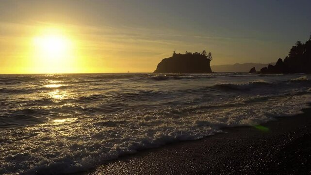 Colorful sunset over Ruby Beach with waves crashing against pebble shoreline in Olympic National Park, Washington state, USA. 4K UHD video.