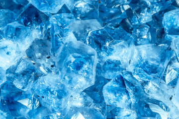 Blue Crystal Mineral Stone. Gems. Mineral crystals in the natural environment. Texture of precious and semiprecious stones. Seamless background with copy space colored shiny surface of precious stones
