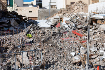 Pile of rubble surrounds debris and destruction. Destruction after earthquake or explosion