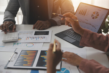 Close up of Business team analyzing income charts and graphs with modern laptop computer. Business analysis and strategy concept.