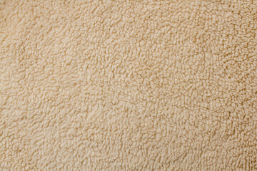 Texture of a jacket with fur. Fabric imitating sheep wool